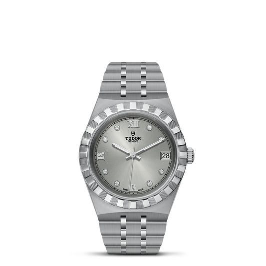 The TUDOR Royal, a sport-chic timepiece, highlights a silver Tudor watch with a stainless steel bracelet and a bezel adorned with intricate grooves. Its metallic gray dial is embellished with silver Roman numerals and diamond hour markers, enhanced by the presence of a date window at 3 o'clock for an elegant touch.