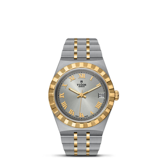 Discover the sophistication of the TUDOR Royal with this exquisite silver and gold watch by TUDOR. Its round dial is adorned with gold Roman numerals, a date display, and a fluted bezel. This automatic sport-chic creation boasts an integrated two-tone metal bracelet, epitomizing timeless elegance.