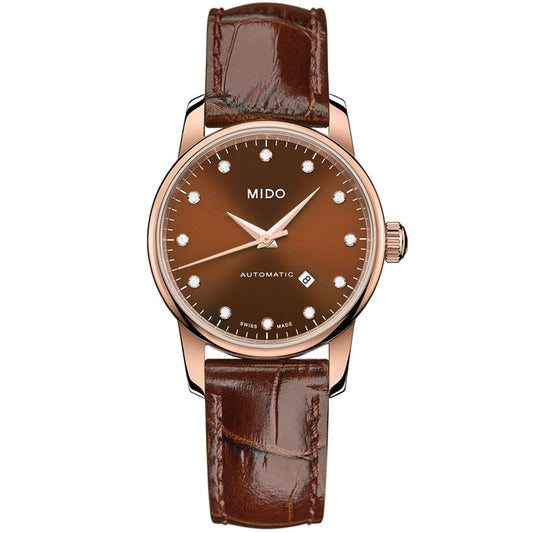 The MIDO Baroncelli II Lady Automatic 29mm features a brown leather strap, rose gold case, brown dial with diamond markers, automatic movement, date at 6 o’clock, and three hands.