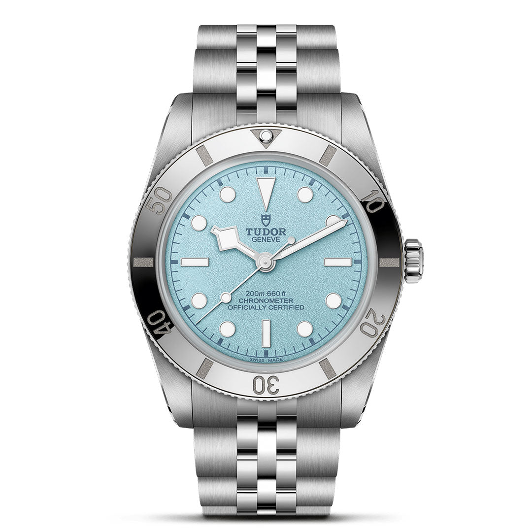 The TUDOR Black Bay 54 Lagoon Blue features a 37mm silver case, stainless steel bracelet, light blue textured dial, silver bezel, white hour markers, date window, and is water-resistant to 200m. Inspired by the iconic TUDOR dive watch.