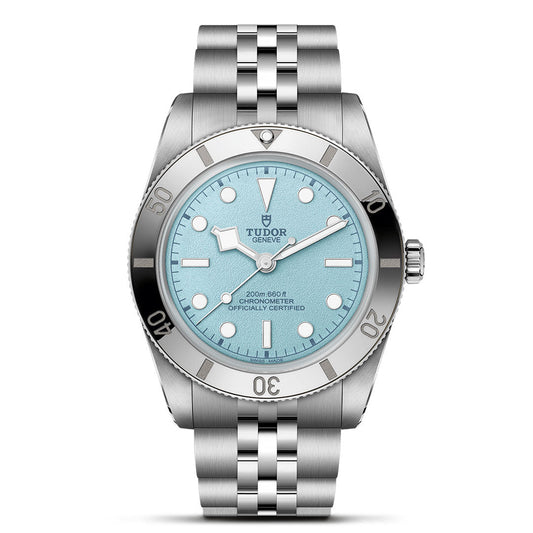 The TUDOR Black Bay 54 Lagoon Blue features a 37mm silver case, stainless steel bracelet, light blue textured dial, silver bezel, white hour markers, date window, and is water-resistant to 200m. Inspired by the iconic TUDOR dive watch.