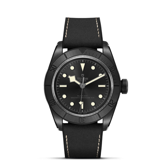 The TUDOR Black Bay Ceramic wristwatch showcases a matte black ceramic case with luminous dot hour markers and a sophisticated black leather strap. Featuring a rotating bezel with minute markings, the round dial highlights the "TUDOR" logo at its center, providing both style and precision as a Master Chronometer.