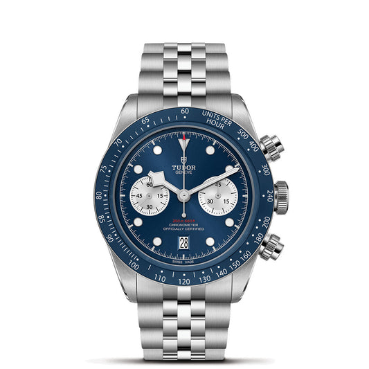 The TUDOR Black Bay Chrono Blue is a boutique-exclusive stainless steel watch with a striking blue dial, silver subdials, date at 6 o’clock, silver bracelet, and tachymeter bezel marked "UNITS PER HOUR.