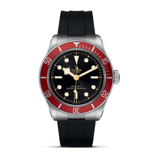 Explore the captivating elegance of the TUDOR Black Bay, a luxury wristwatch influenced by TUDOR divers' watches. Featuring a black face with bold white hour markers and a striking red bezel, this watch radiates timeless sophistication. Its neo-vintage design is beautifully complemented by a black rubber strap and silver casing for an unmistakable sense of style.