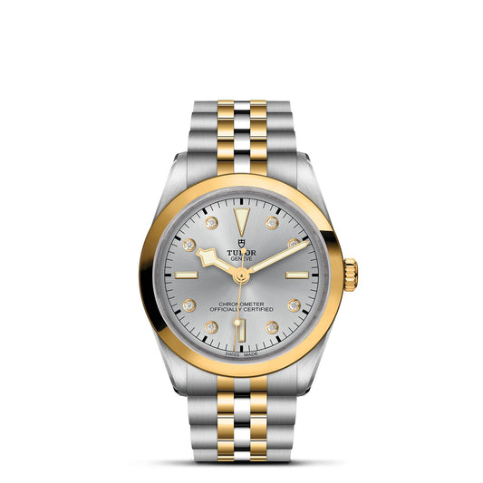 The TUDOR Black Bay One 36 S&G is a luxury wristwatch with a 36mm steel case, silver dial, gold bezel and markers, gold and silver stainless steel bracelet, date display, and "Chronometer Officially Certified" on the dial—a stunning piece in the Black Bay collection.