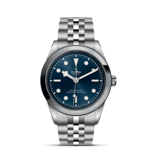 The TUDOR Black Bay One 41 showcases a captivating blue face with luminescent hands, round hour markers, and a date window at 3 o’clock. It has a robust steel case and five-link metal bracelet, ideal for fans of TUDOR divers' watches.