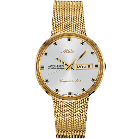 The MIDO Commander 1959 Automatic 37mm Watch features a gold mesh band, white dial with gold hour markers and hands, day-date display at 3 o’clock, and “MIDO” and “Commander” on the dial.