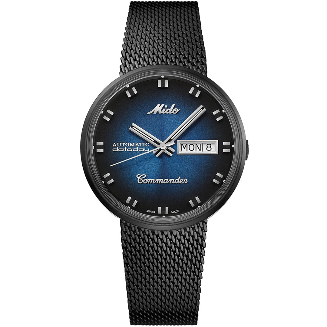 The MIDO Commander Shade Automatic 37mm Watch features a black Milanese mesh bracelet, blue gradient dial with silver markers and hands, and shows day and date in a right-side rectangular window. COSC-certified chronometer.