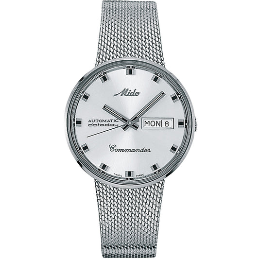 The MIDO Commander 1959 Automatic 37mm Watch features a silver dial, black hour markers and hands, day-date display on the right, automatic movement, and a silver mesh integrated bracelet.