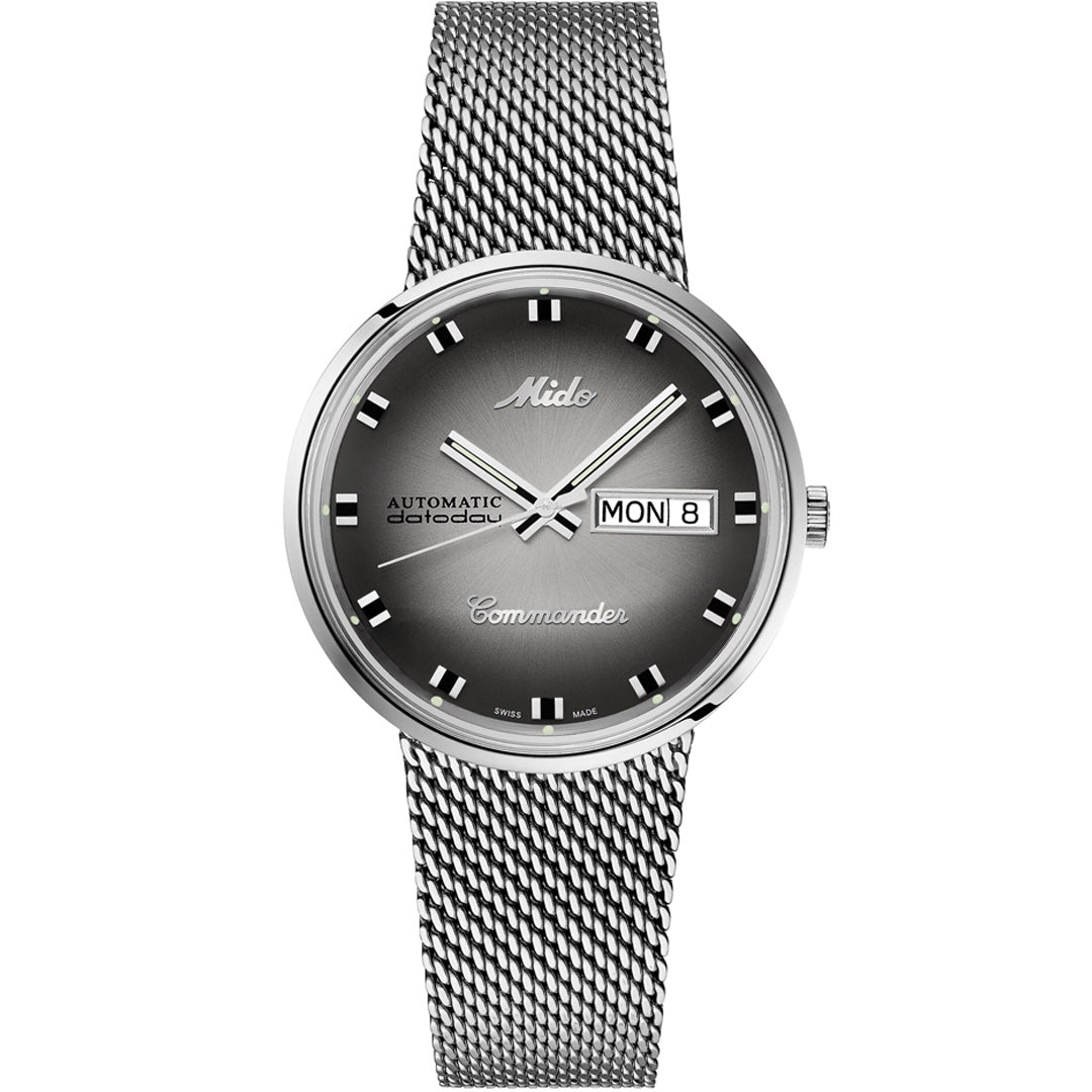 The MIDO Commander Shade Automatic 37mm watch features a silver Milanese mesh bracelet, gradient black dial, silver hour markers, and day-date display at 3 o’clock with "Automatic" and "Commander" on the face.