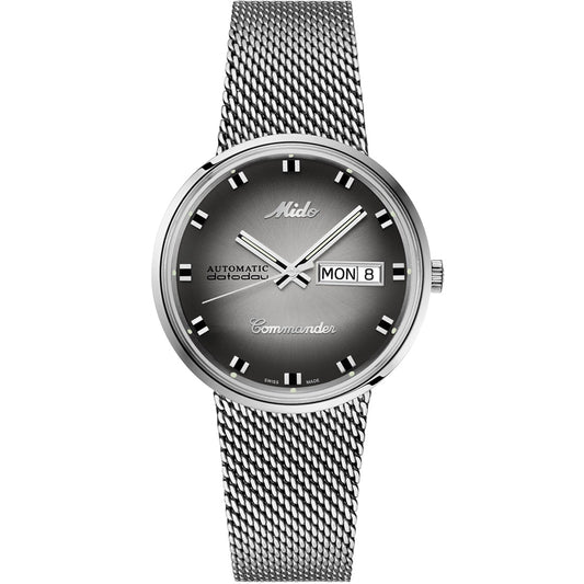The MIDO Commander Shade Automatic 37mm watch features a silver Milanese mesh bracelet, gradient black dial, silver hour markers, and day-date display at 3 o’clock with "Automatic" and "Commander" on the face.