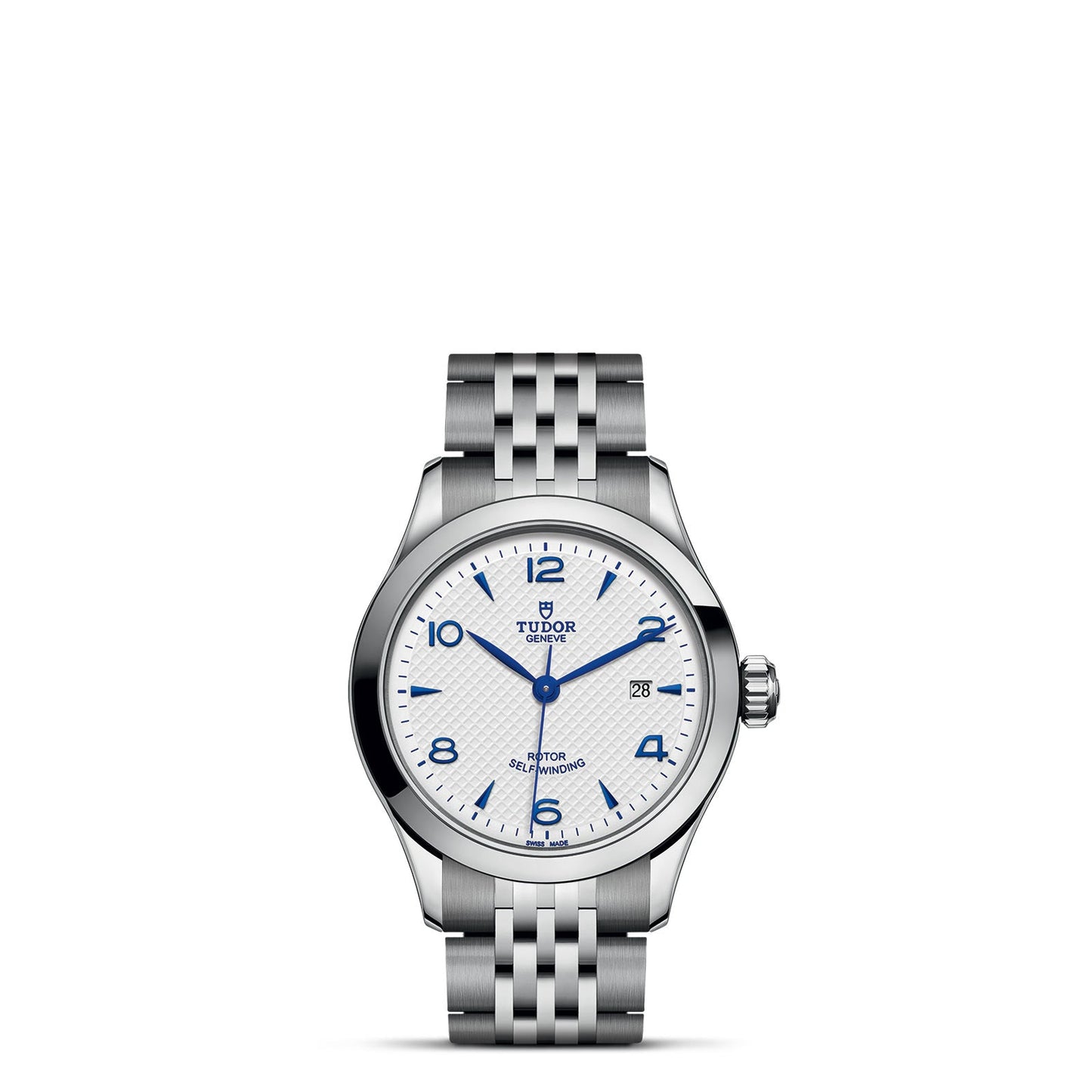 The TUDOR 1926 wristwatch by TUDOR exudes timeless elegance with its silver finish and white dial, accented by blue hour markers and numerals at the 12, 3, 6, and 9 positions. It includes a date window at the 3 o'clock position and features a patterned metal bracelet, embodying the classic allure of mechanical watches.