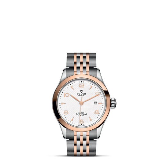 The TUDOR 1926 collection showcases a remarkable timepiece in silver and rose gold featuring a white dial with a date window positioned at 3 o'clock and numeric-bar markers. The watch's bezel and links create an elegant contrast by blending polished steel with rose gold tones, capturing the spirit of exquisite mechanical craftsmanship.