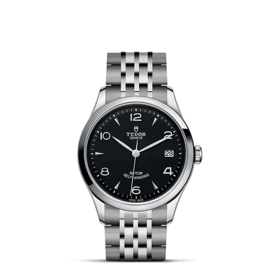 Presenting the TUDOR 1926, a stylish silver wristwatch featuring a black textured dial adorned with white hour markers and hands. It offers a date display conveniently located at the 3 o'clock position. The sophisticated five-link polished metal bracelet is ideal for enthusiasts of mechanical watches.