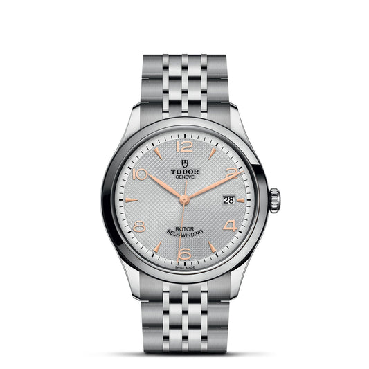 The TUDOR 1926 watch features a stainless steel bracelet and a round face with a textured white dial. It includes rose gold-tone hour markers and hands, as well as a date window at the 3 o'clock position. The TUDOR logo is elegantly positioned below the 12 o'clock marker.