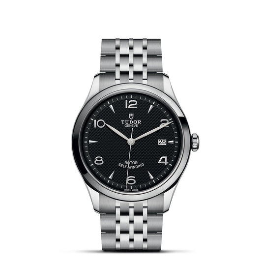 The TUDOR 1926 stainless steel watch boasts a black textured dial with Arabic numerals and index markers, a date display at 3 o'clock, and a link bracelet. This mechanical watch is labeled "Rotor Self-Winding.