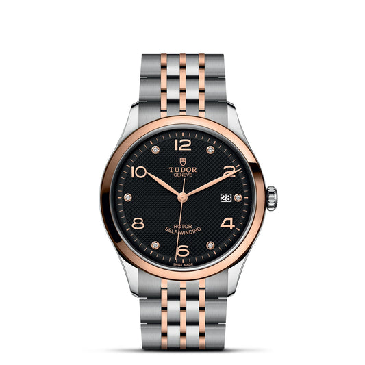 Part of the TUDOR 1926 collection, this elegant wristwatch from TUDOR showcases a black textured dial adorned with rose gold numerals and diamond-set silver and rose gold hour markers. The watch includes a date display at the 3 o'clock position and is complemented by a stylish two-tone metal bracelet in silver and rose gold.