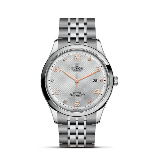 The TUDOR 1926 from the TUDOR brand showcases a textured white dial accented by rose gold hour markers and Arabic numerals at 3, 6, 9, and 12. It includes a date window positioned at 3 o'clock and is tastefully finished with a five-link stainless steel bracelet, exemplifying timeless sophistication in mechanical watches.