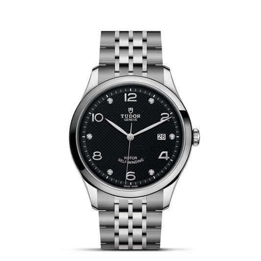The TUDOR 1926, a silver wristwatch by TUDOR, showcases a black textured dial adorned with white Arabic numerals at 3, 6, 9, and 12 o'clock. It includes a date window at the 3 o'clock position and features diamond markers for other hour positions. This sophisticated timepiece is complemented by a polished stainless steel bracelet.