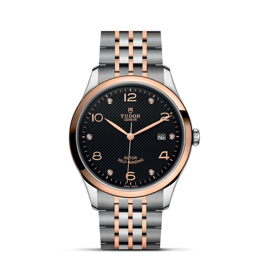 This TUDOR 1926 luxury wristwatch boasts a silver and rose gold metal strap. Its black dial highlights rose gold hour markers, hands, and a date display, with the TUDOR brand name prominently featured on the upper portion of the dial.