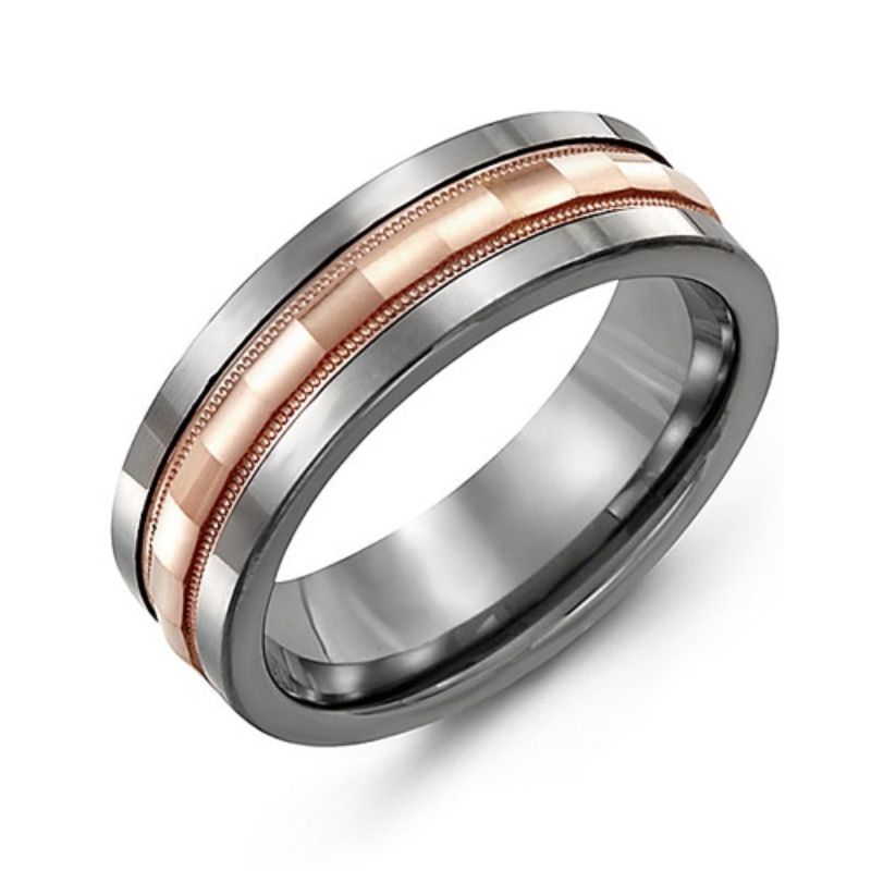 The Madani Tungsten and 10K Rose Gold Wedding Band showcases a sleek tungsten band with a central strip that exudes the warmth of a 10k rose gold finish. The dual-tone design features an intricate pattern, and the ring is displayed at an angle on a plain background.