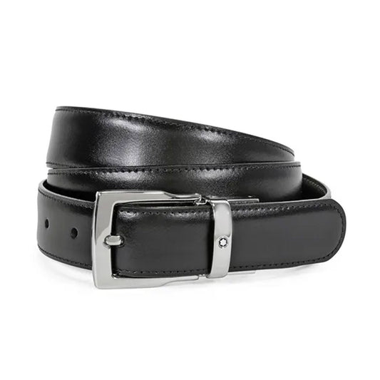 The Montblanc Reversible Black/Brown Classic Leather Belt is coiled neatly, featuring a shiny silver buckle. It highlights a smooth finish and multiple adjustment holes, showcasing its versatility and stylish design.