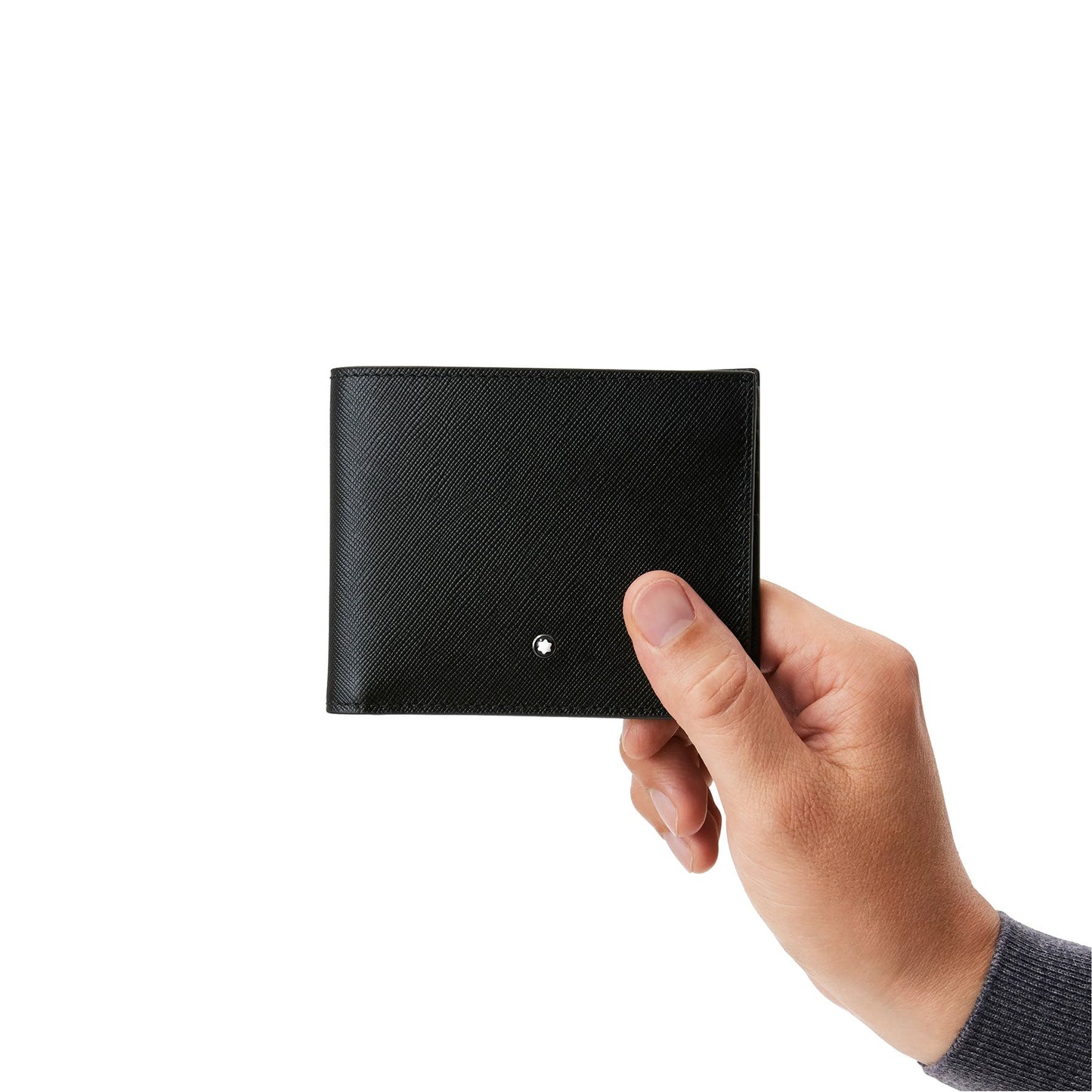 A hand presents a closed Montblanc Sartorial Wallet 6cc, made of Italian full-grain calfskin leather, against a plain white background.