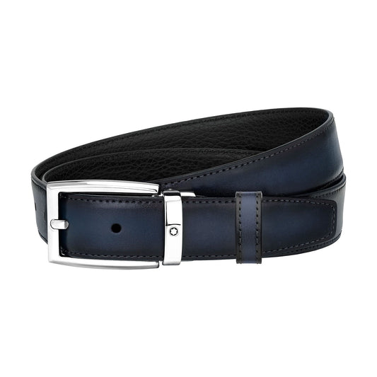 The Montblanc Reversible Blue / Black Business Leather Belt features a sleek, dark leather finish with a polished silver buckle and a single loop. Its neat coil highlights the smooth texture and luxurious design characteristic of the Montblanc brand.