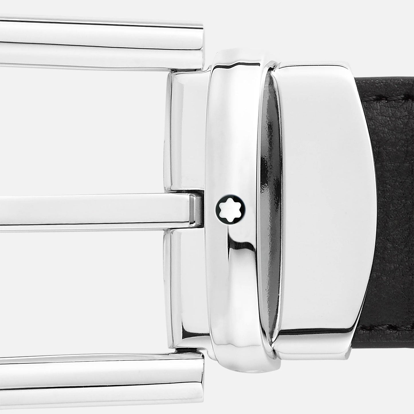 A close-up reveals the refined metallic buckle of the Montblanc Horseshoe Leather Belt, showcasing a polished palladium finish adorned with a distinctive white star emblem. The black leather belt, branded by Montblanc, is partially visible to the right side of the buckle against a light gray backdrop.