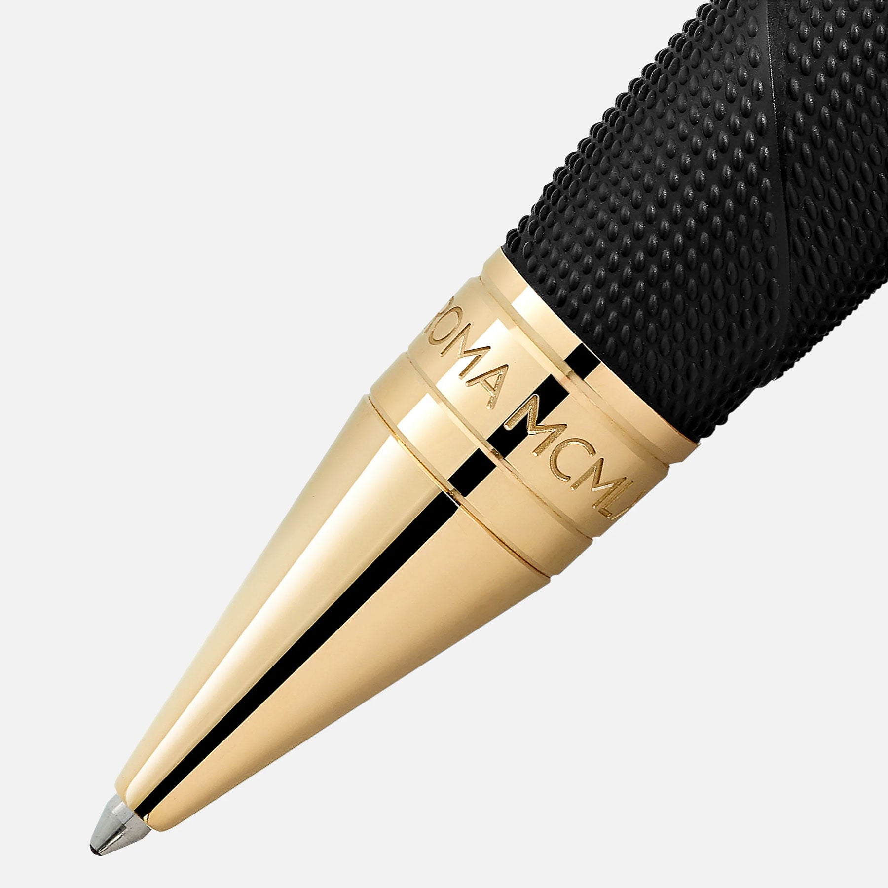 Close-up of the Montblanc Great Characters Muhammad Ali Special Edition Ballpoint Pen, showcasing a textured black grip and a shiny gold tip. This Montblanc pen, embodying the prowess of the heavyweight champion, features engraved writing on the gold section, delivering an elegant and sophisticated look against a plain light background.