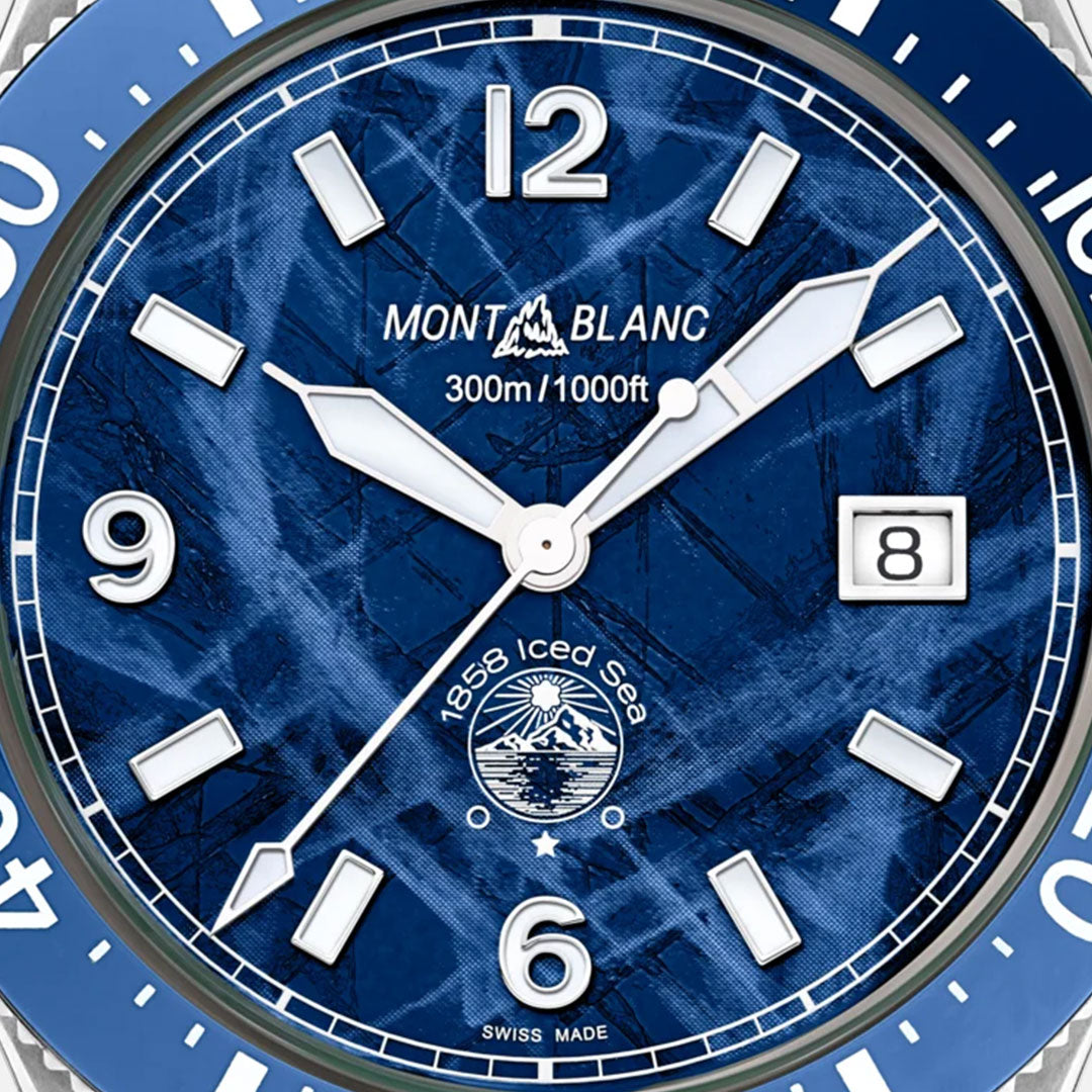 Close-up of the Montblanc Iced Sea Automatic 41mm Watch, highlighting its glacier-patterned blue dial. The dial prominently features "Montblanc" and "300m/1000ft," along with bold white hour markers. It includes a date window at 3 o'clock, the words "1858 Iced Sea" accompanied by a mountain logo near the 6 o'clock position, and "Swiss Made" noted at the bottom.