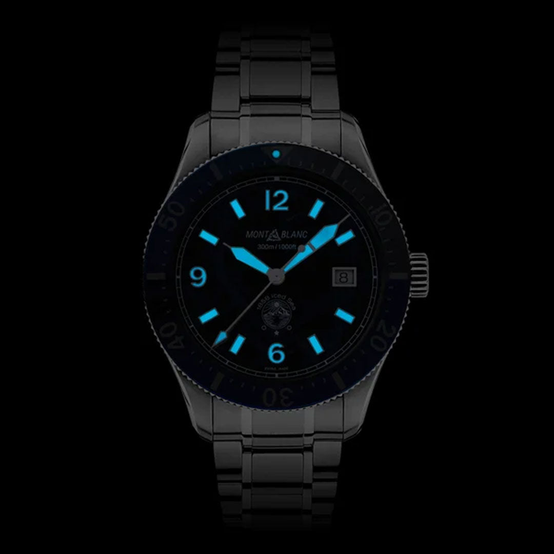 The Montblanc Iced Sea Automatic 41mm Watch showcases a sleek black metal strap paired with luminescent blue numerals, enhanced by a striking glacier pattern dial. This sporty diving timepiece includes a date display, prominent white hour markers, and glow-in-the-dark features that contrast beautifully with the dark backdrop.