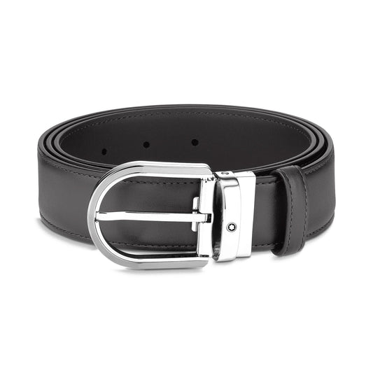 The Montblanc Horseshoe Leather Belt, a sleek black piece from Montblanc, is coiled neatly with its shiny horseshoe buckle. The buckle showcases a classic design with a single prong and a small decorative detail.
