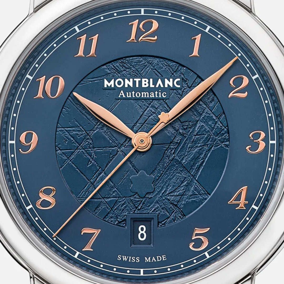 The dial close-up of the Montblanc Star Legacy Automatic 39mm Watch reveals a captivating blue glacier pattern, highlighted by rose gold Arabic numerals and hands. The design features a date window at 6 o'clock, with "MONTBLANC" and "Automatic" prominently showcased to emphasize its superior automatic movement.