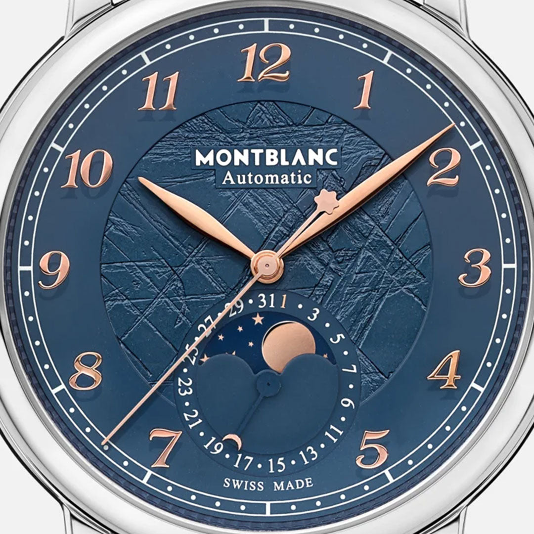 A detailed look at the Montblanc Star Legacy Moonphase Automatic 42mm Watch Limited Edition showcases an exquisite glacier-patterned dial in blue hues, highlighted by rose gold-coated hands and numerals. This limited edition piece includes a moon phase display and a date indicator within its circular design, with "Swiss Made" elegantly positioned at the bottom of the watch face.