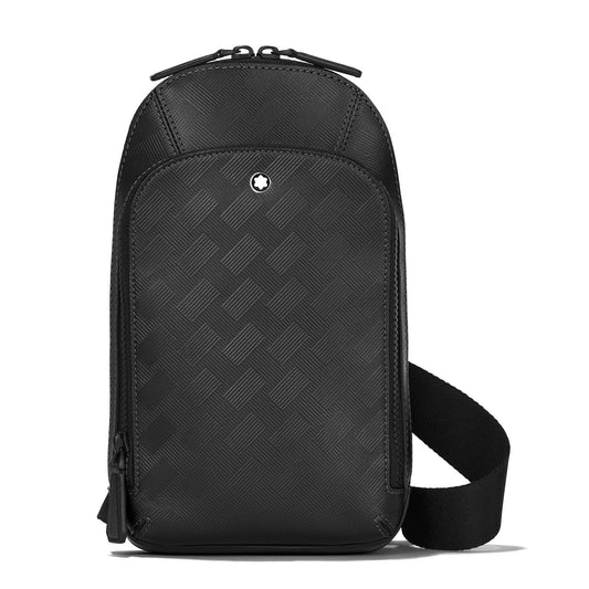 Introducing the Montblanc Extreme 3.0 Black Leather Sling Bag, a sophisticated accessory by Montblanc. This stylish sling bag showcases a sleek black design with a textured geometric pattern made from premium full-grain leather. It is equipped with a zippered top closure and adorned with a small emblem on the front. The adjustable strap is side-attached, offering both style and versatility for any occasion.