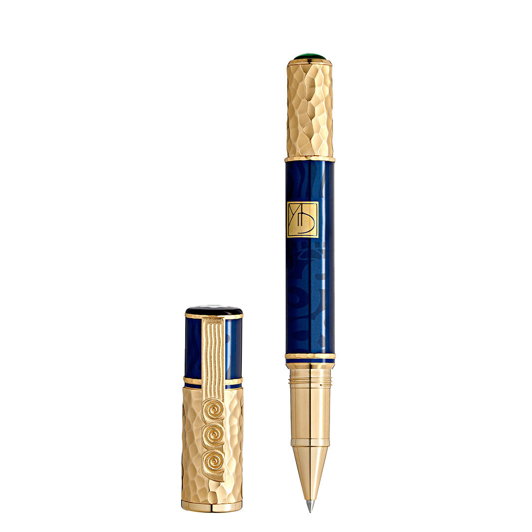 The Montblanc Masters of Art Homage to Gustav Klimt Limited Edition 4810 rollerball pen features a gold textured cap and end, blue barrel, and intricate gold details inspired by the Vienna Secession; its cap is displayed separately beside the pen.