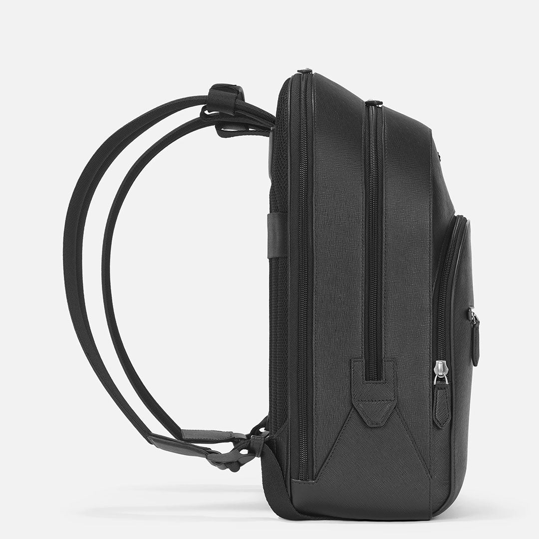 Side view of the Montblanc Sartorial Large 3 Compartments Leather Backpack Bag in black Saffiano leather, featuring adjustable straps and a side zip pocket—ideal for business trips. Shown against a plain white background.