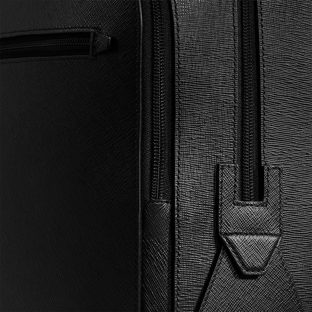 Close-up of the Montblanc Sartorial Medium 3 Compartments Leather Backpack Bag in black Saffiano leather, showing detailed stitching, a vertical zipper with leather pull tab, and part of a small zippered pocket on the left.
