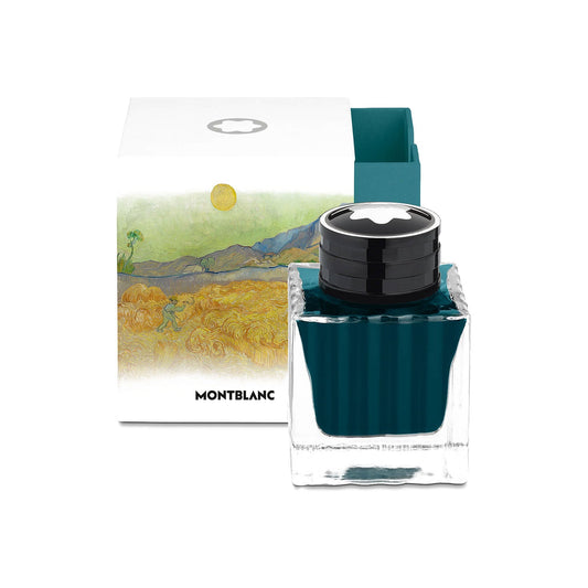 A Montblanc Ink bottle 50ml Turquoise Homage to Vincent Van Gogh is gracefully showcased in front of its packaging, which depicts an artistic landscape with a vibrant yellow sun and lush green fields. This special edition ink, a deep teal color, is perfect for those who value collectible gifts.