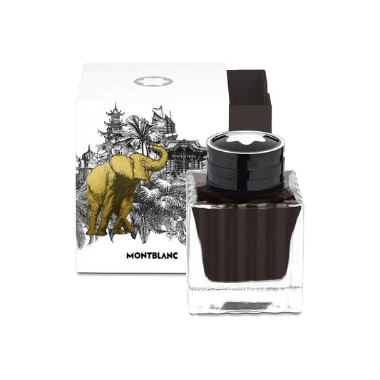 This Collector's Edition square glass bottle from Montblanc is filled with luxurious brown Meisterstuck Around the World in 80 Days ink. The white box features a design with an elephant and intricate landscape illustrations in black and gold, making it an ideal choice for collectible gifts.