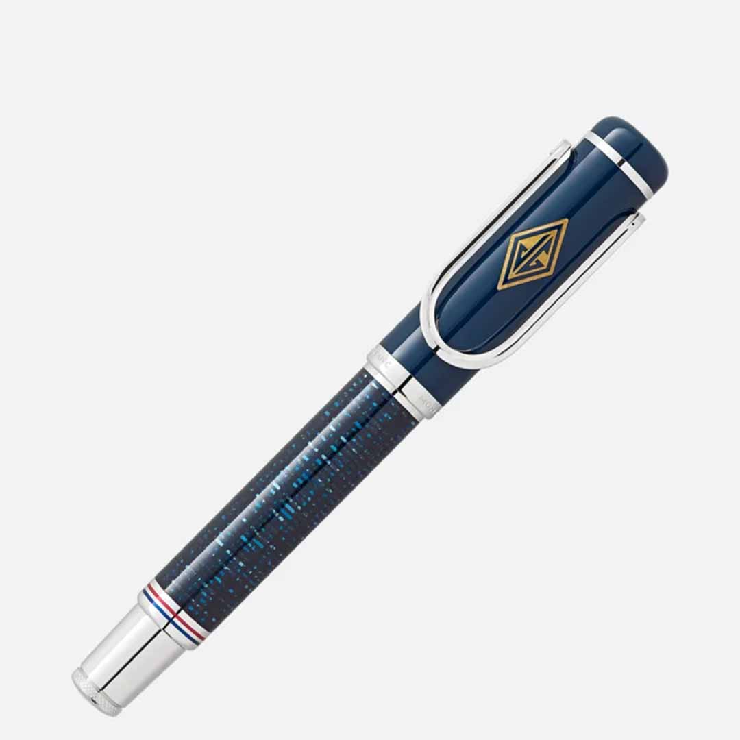 The Montblanc Great Characters Homage to The Great Gatsby Special Edition Rollerball Pen from Montblanc features a sleek blue and silver design reminiscent of the Jazz Age, with a glossy barrel and gold geometric pattern on the cap, capturing the elegance of The Great Gatsby against a light gray background.