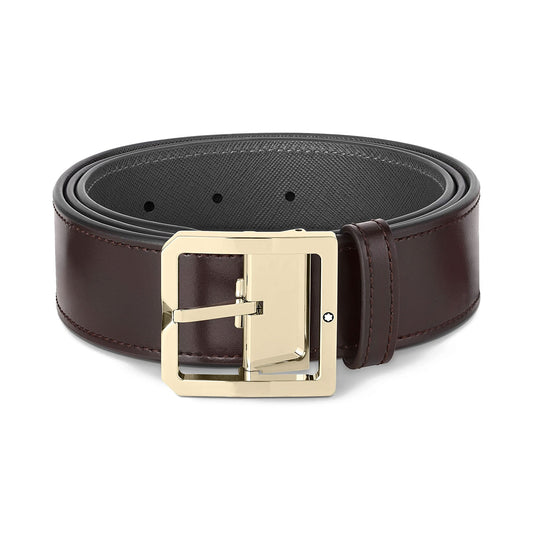 The Montblanc Reversible 40mm Black/Brown Leather Belt, featuring a shiny gold rectangular buckle, gleams under the light. This elegant belt showcases visible adjustment holes and a smooth, sophisticated texture, making it a timeless accessory for any wardrobe.