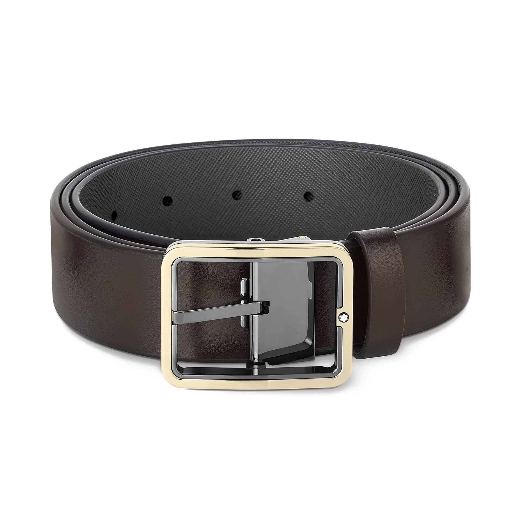 A Montblanc Reversible 35mm Black/Brown Leather Belt is coiled neatly, featuring a sleek dark brown finish on one side and a silver rectangular buckle. The belt includes multiple adjustment holes and showcases a subtle textured design.