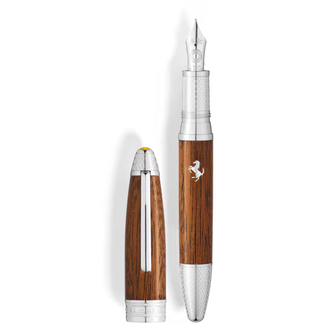 The Montblanc Meisterstück Great Masters Ferrari Tailor Made Classica Special Edition Fountain Pen features a woodgrain body, silver accents, and a silver emblem, with its cap upright beside the elegant uncapped pen.