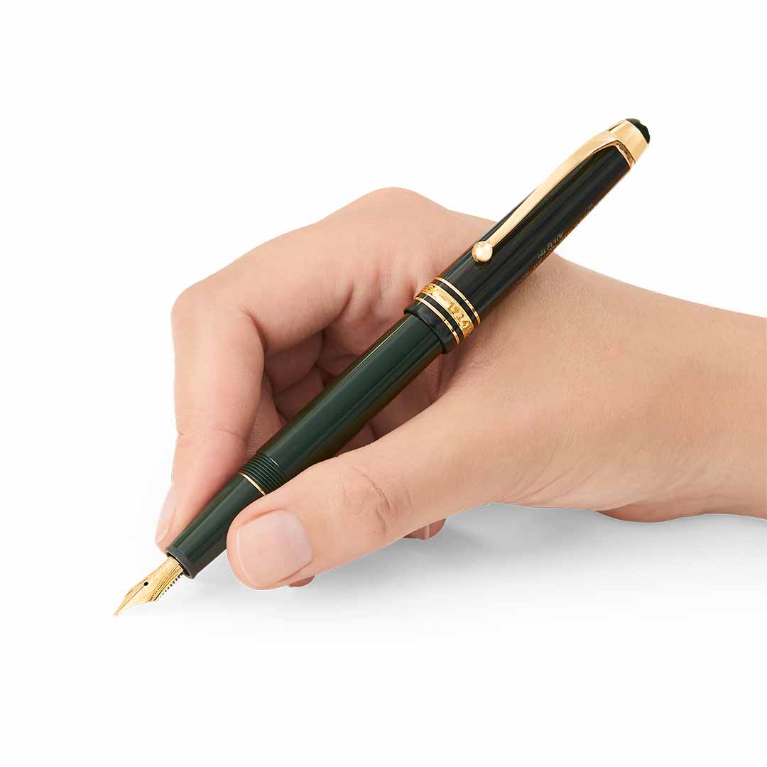 A hand holds the luxurious Montblanc Meisterstück The Origin Collection Precious Resin Fountain Pen Classique M, poised for writing. Its elegant design features a sparkling gold nib and clip, captured against a plain white background, exemplifying a fine writing instrument.