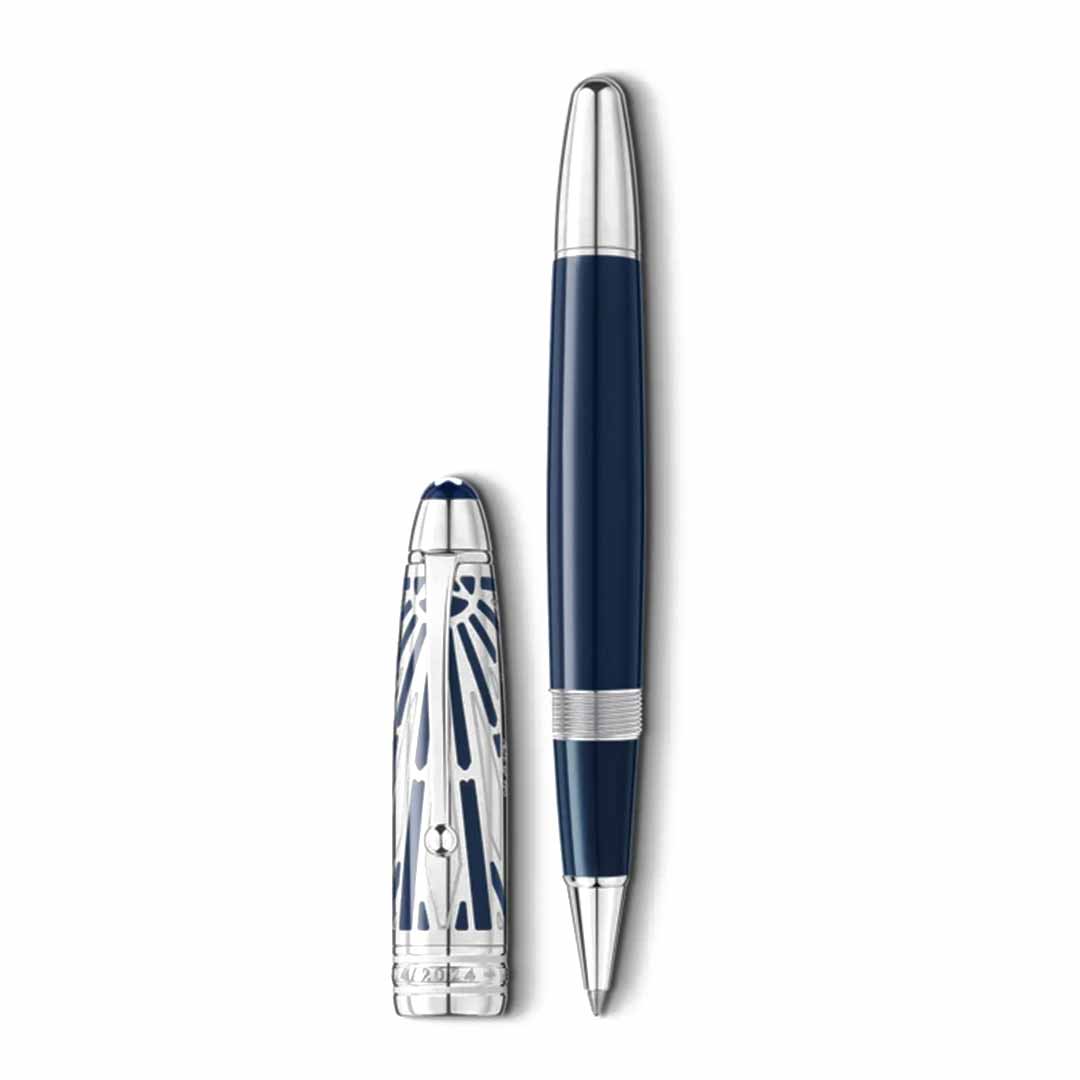 The Montblanc Meisterstuck The Origin Collection Doue Le Grand Rollerball Pen, with its sleek silver and blue design and intricate cap detailing, stands upright on a white background. This fine writing instrument is elegant and showcases shiny metallic accents.