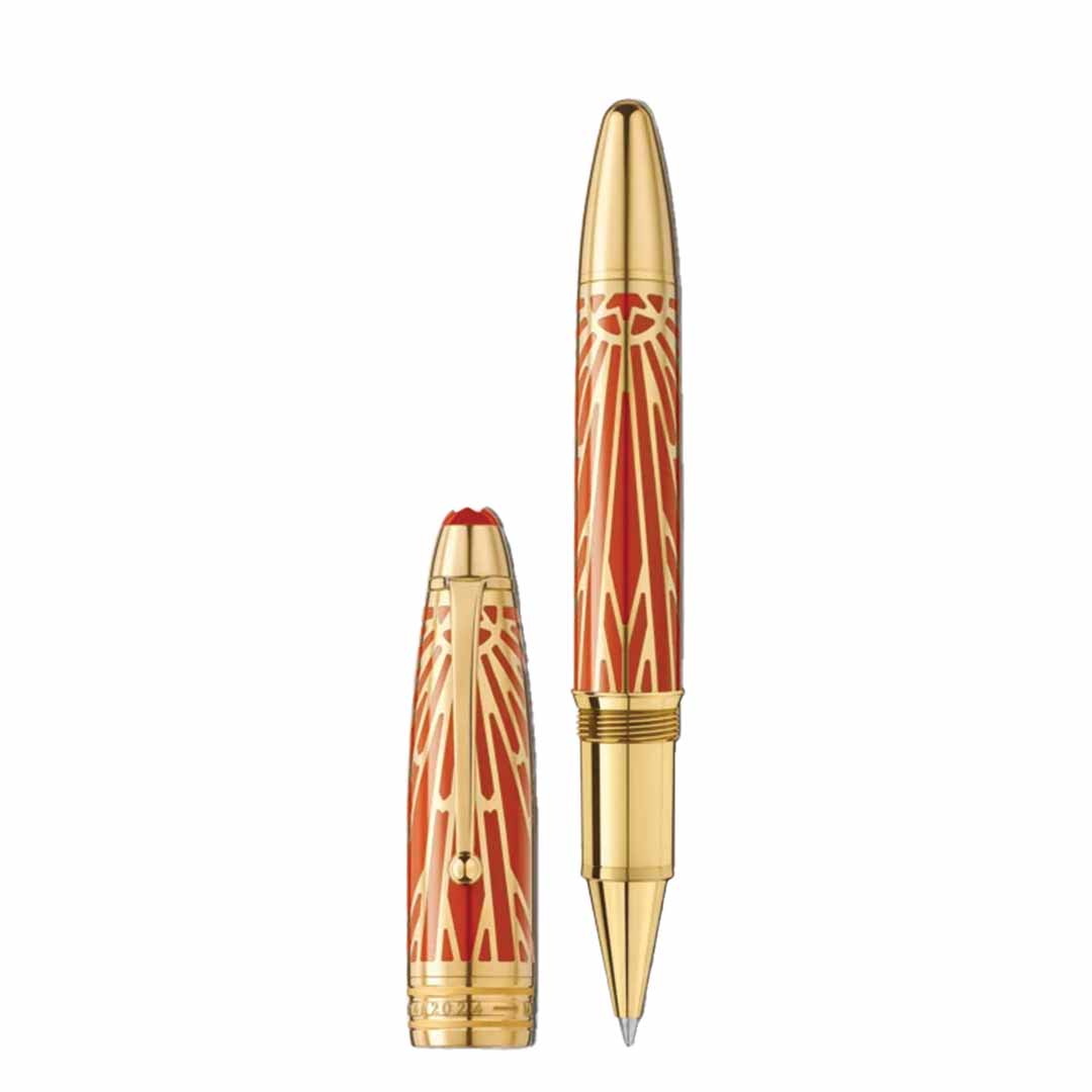 The Montblanc Meisterstück The Origin Collection Solitaire Legrand Rollerball Pen boasts a luxurious gold and red design, adorned with intricate patterns. Displaying its exquisite craftsmanship, the cap is removed and placed alongside this finely crafted Montblanc writing instrument.