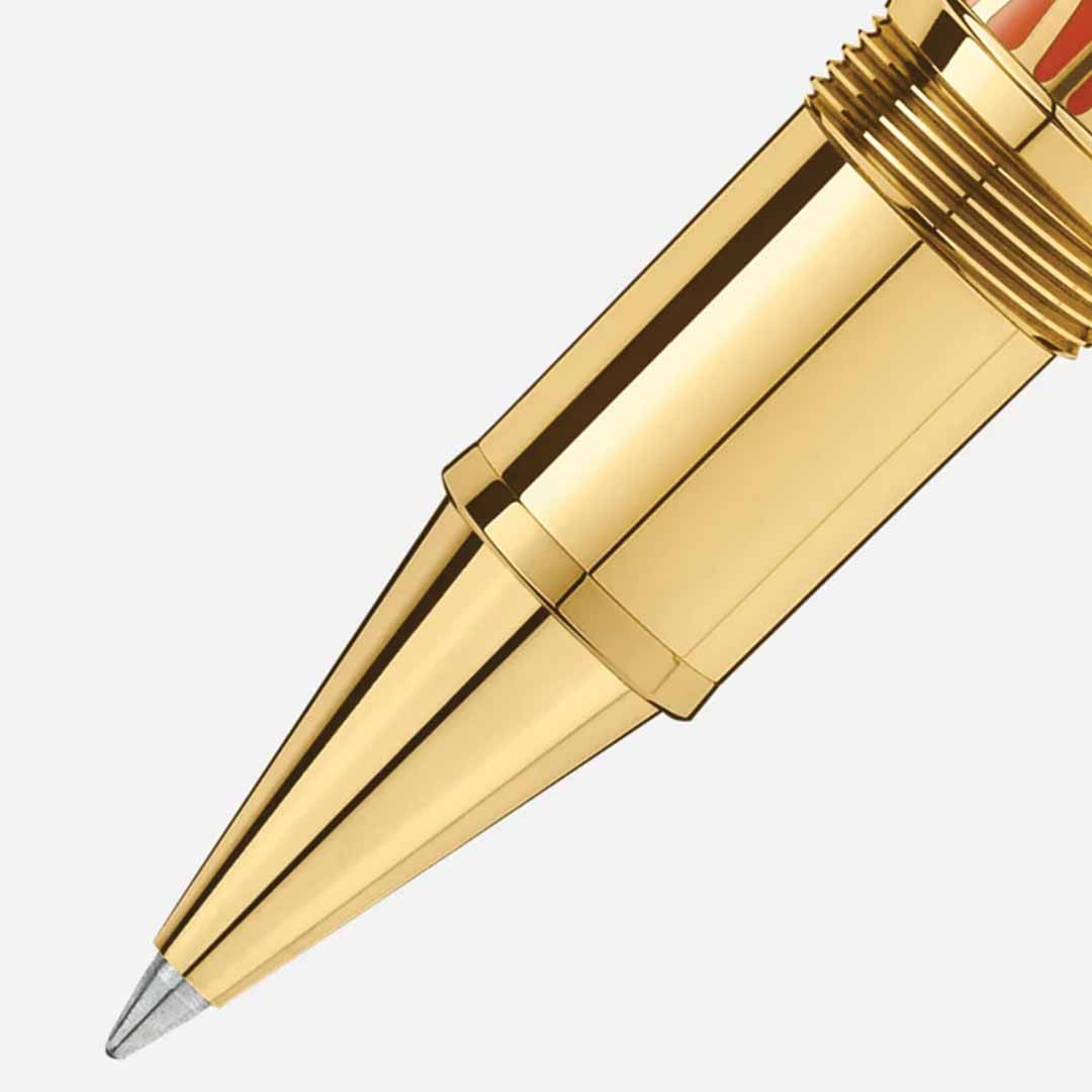 Close-up of a Montblanc Meisterstuck The Origin Collection Solitaire Legrand Rollerball Pen tip against a plain background. This fine writing instrument from Montblanc features a shiny, metallic body with a pointed end, epitomizing elegance and precision in every stroke.