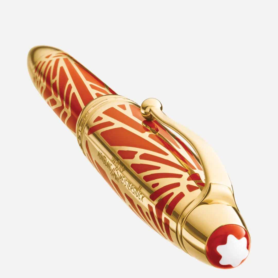 The Montblanc Meisterstück The Origin Collection Solitaire Legrand Rollerball Pen is a luxurious fine writing instrument with a red and gold patterned design, featuring a gold clip and Montblanc's iconic white star emblem on the cap.